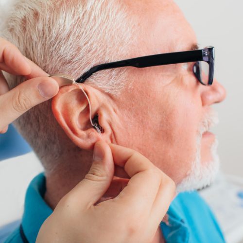 man having hearing aids fitted