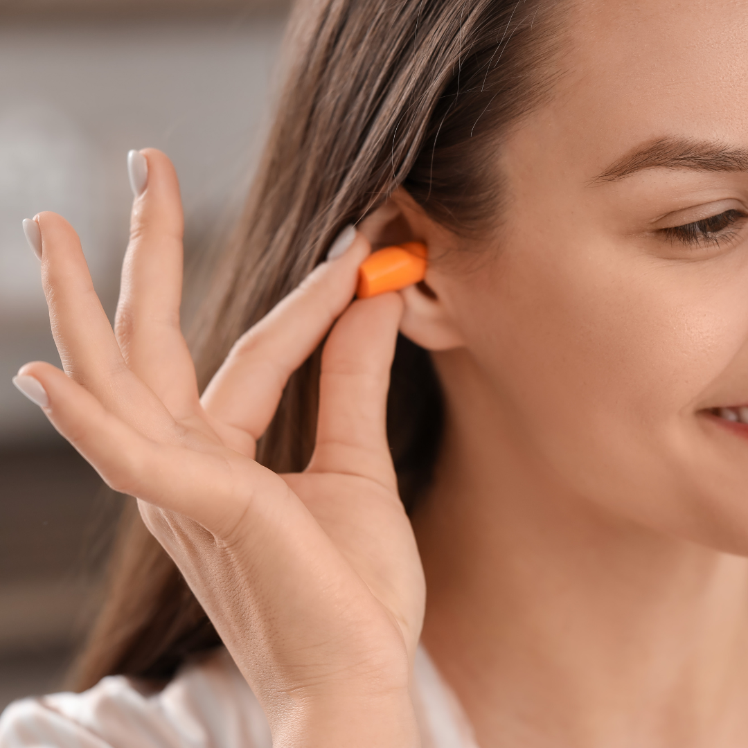 Woman putting in ear plugs